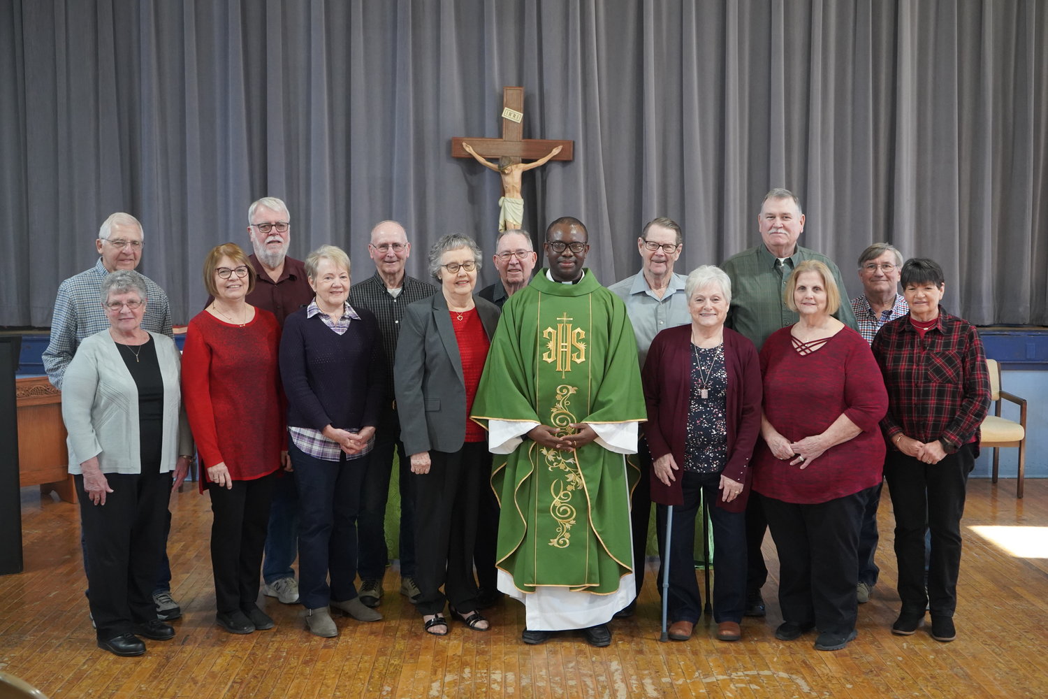 A group with over 1,000 years of combined experience of being married joins Father Ernest Dike for a photo after Mass in the Montgomery City Knights of Columbus Hall on Valentine’s Day.